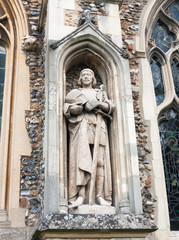 Fototapeta na wymiar statue of man on the outside of english christian church made of stone