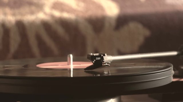 Vintage record player with vinyl disc, close-up. warm sunlight