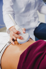 female doctor operating ultrasound scanner