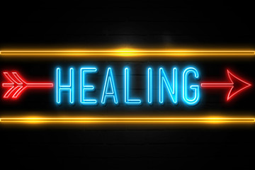 Fototapeta premium Healing - fluorescent Neon Sign on brickwall Front view