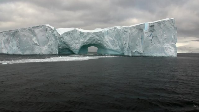 Arch of Darwin huge giant unique glacier iceberg in ocean of Antarctica. Amazing beautiful wilderness nature and landscape of white mountains. Extreme tourism cold desert north pole.