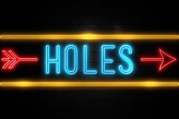 Holes  - fluorescent Neon Sign on brickwall Front view