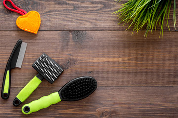 care about pet with brushes and grooming equipment on wooden background top view mockup
