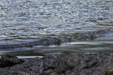Contaminated oil stains mixed with sea water