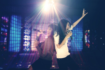 Two women singing in the night club