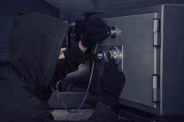 Male thief stealing a bank vault