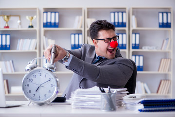 Clown businessman working in the office angry frustrated with a 