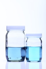 Red Liquid in Glass Bottle white cap
