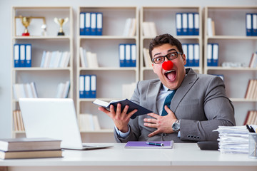 Fototapeta premium Clown businessman working in the office