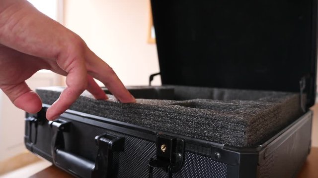 A man puts a homemade explosive device in his suitcase. Preparation of terrorist act. 4k. Slow motion