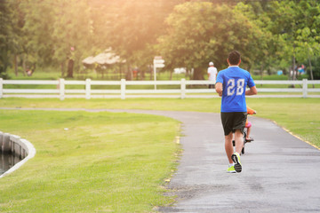 Fototapeta premium Athletic young man running in the park. Healthy lifestyle