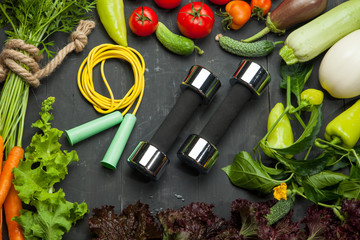 Fresh vegetables, diet and sport on a black wooden background - 170205436