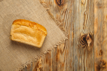 Wheat and traditional bread on a wooden background