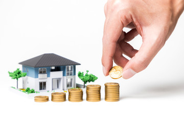 real estate and funds, hand holding a coin