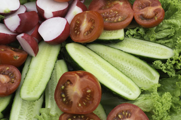  table with chopped vegetables in women's hands. large pieces