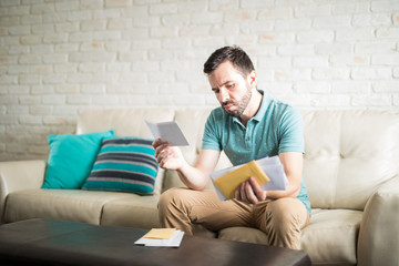 Worried man reading mail
