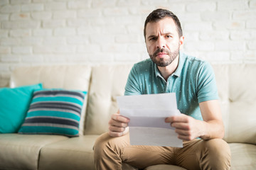 Attractive man reading correspondence