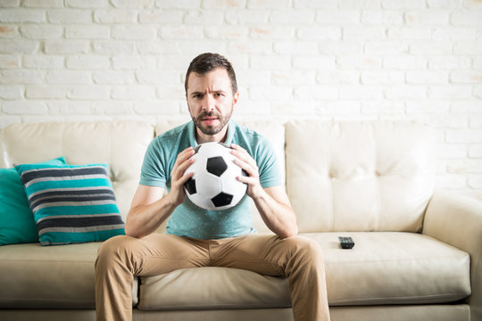 Latin man holding a soccer ball