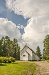 Fototapeta na wymiar Rural White Church with a Cross 