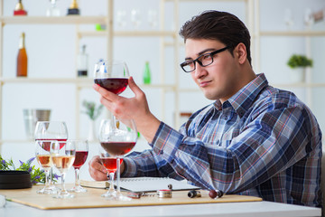 Professional sommelier tasting red wine 