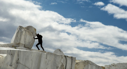 A small human female figure pushing a large marble stone. Sisyphus metaphor. Heavy tasks and...