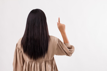 woman back side pointing up to blank isolated space