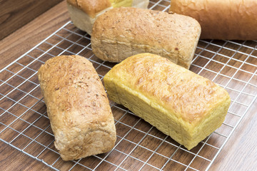Naklejka premium Many mixed homemade breads loaf on wood table
