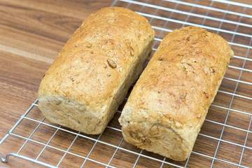2 homemade multigrain bread loaf on wood table