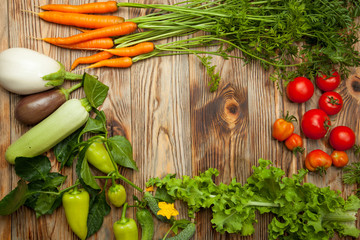Raw vegetables on a wooden background