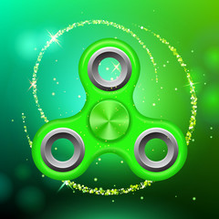 Green colorful spinner on an abstract background with green luminous backdrop. Abstract background with green luminous backdrop. Modern children's toy - spinner.