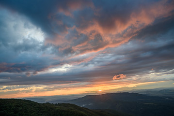 Powerful summer storm approaching the mountains in Sofia, Bulgaria under the beautiful golden light of the setting sun