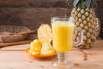 Pineapple smoothie  on wood background