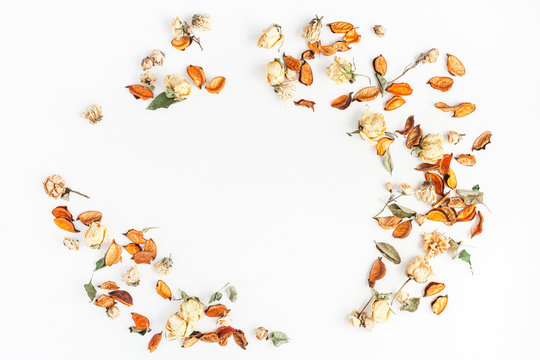 Autumn composition. Frame made of autumn dried flowers and leaves on white background. Flat lay, top view, copy space.