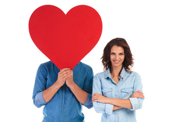 happy young woman with hands crossed standing near lover