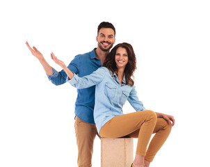 Fototapeta premium happy young casual couple welcoming you