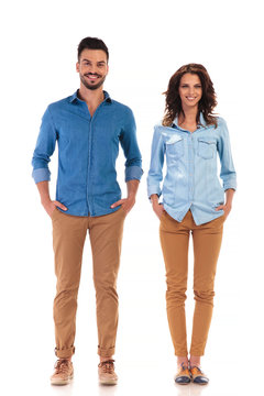 relaxed couple standing with hands in pockets