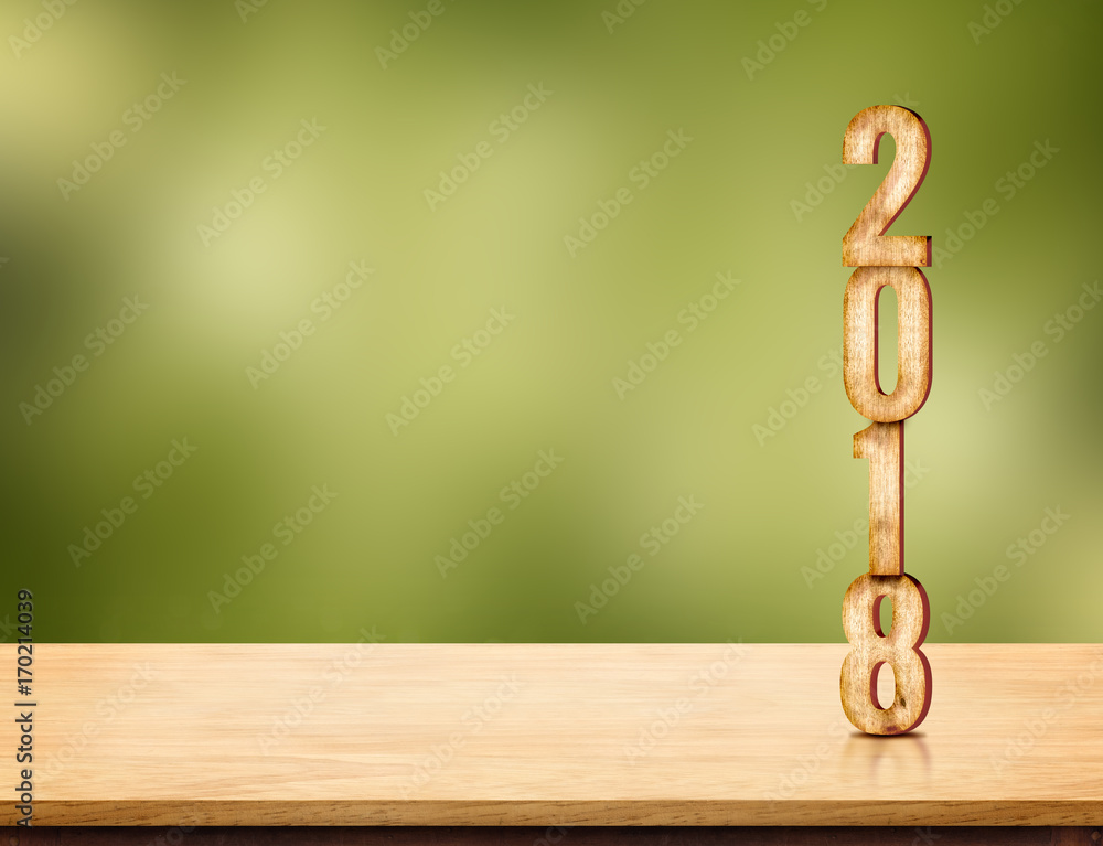 Poster 2018 new year number ( 3d rendering ) on brown wood table top with blur green nature bokeh backgroun