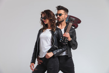 side view of a rock and roll couple standing embraced