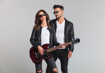 man standing by his rock and roll woman