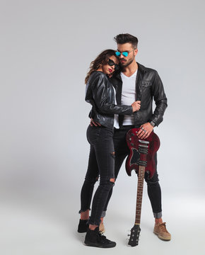 cool rock and roll couple standing embraced,
