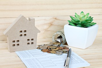 Business, finance, savings, property ladder or mortgage loan concept : Wood house mode, coins...