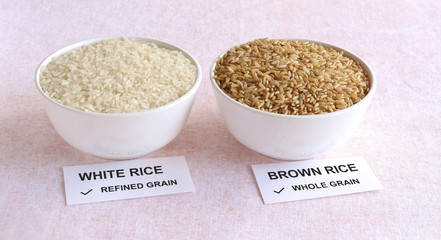 Brown rice, which is a whole grain and healthy food, and white rice, which is a refined grain, in a...