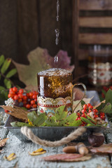 glass of hot tea with autumn leaves