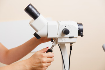 woman gynecologist working with colposcope