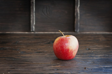 Red sweet apple on the wooden table
