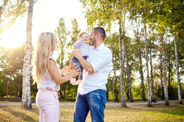 Fototapeta premium Happy family playing with the baby child in the park autumn summer.