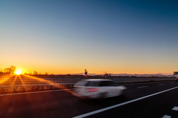 sun goes down behind an industry