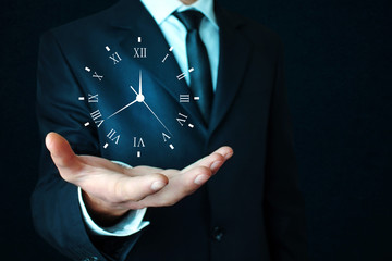 Businessman holding clock. Business time management . - obrazy, fototapety, plakaty