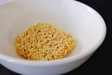 Instant noodles in a white bowl.