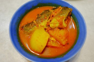 Yellow curry fish with papaya, Thai food in the blue dish food in the south of Thailand.